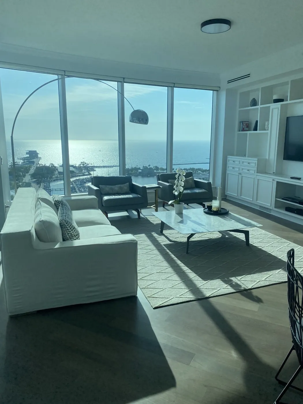 High-rise condo living room with floor-to-ceiling windows over the water